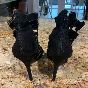 Black suede heel booties by Guess